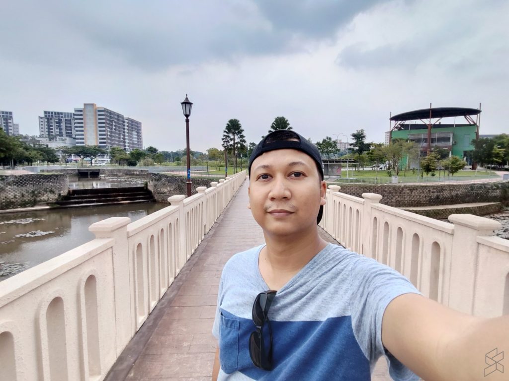 A person standing on a bridge

Description automatically generated